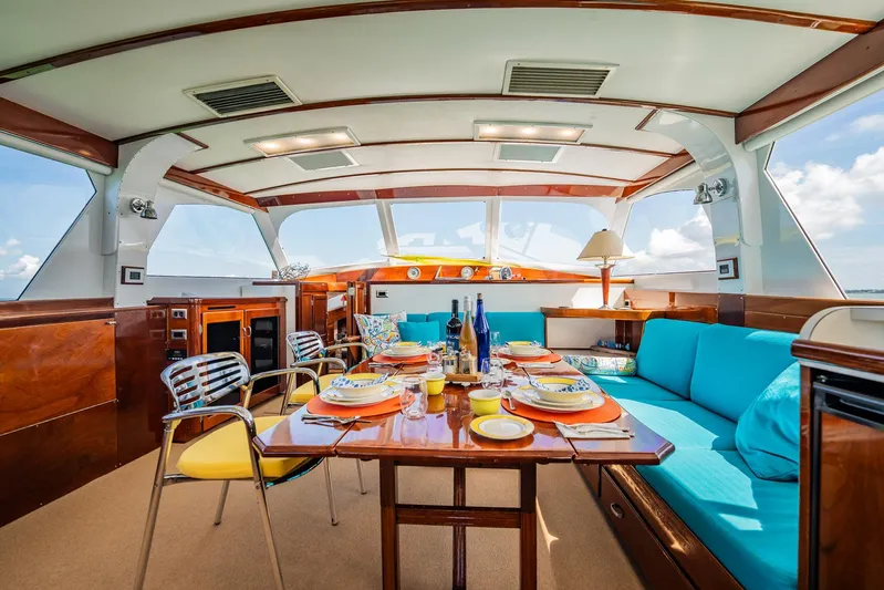 Miss Phebe II Yacht Photos Pics Luxurious interior of a 1971 Whiticar 62 Convertible yacht with elegant dining setup.