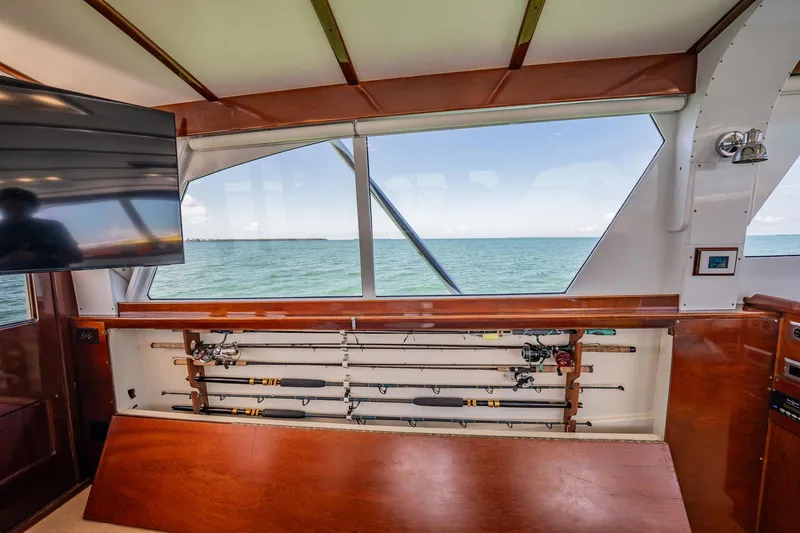 Miss Phebe II Yacht Photos Pics Interior of 1971 Whiticar 62 Convertible yacht with fishing rods and ocean view.