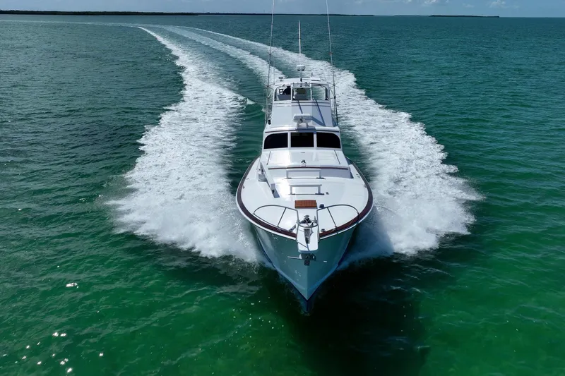 Miss Phebe II Yacht Photos Pics 1971 Whiticar 62 Convertible yacht cruising on open water, leaving a wake behind.