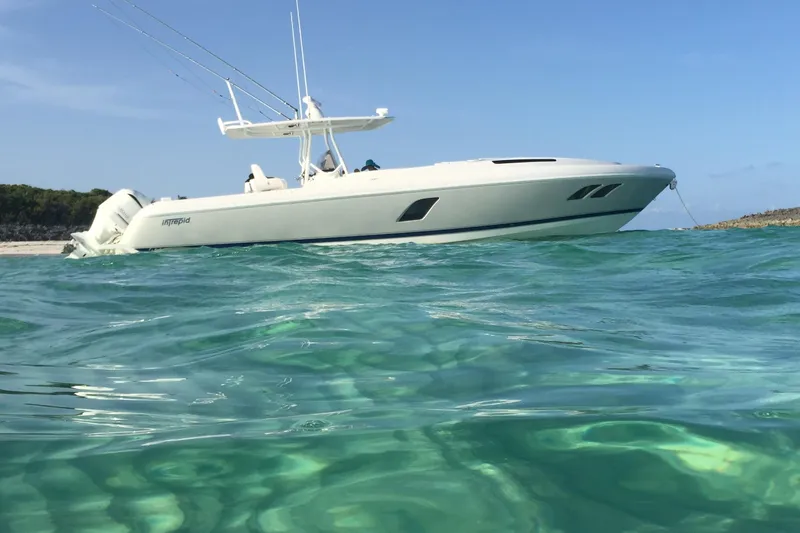  Yacht Photos Pics 2015 Intrepid 400 Cuddy boat anchored in clear turquoise water.