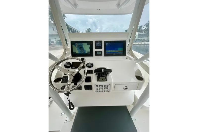  Yacht Photos Pics Control panel of a 2015 Intrepid 400 Cuddy boat with navigation screens and steering wheel.