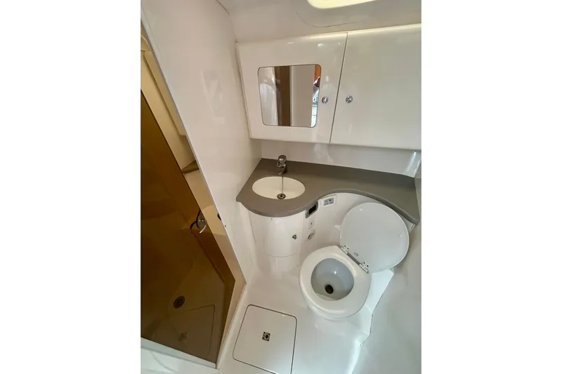  Yacht Photos Pics 2015 Intrepid 400 Cuddy boat bathroom with sink, toilet, and mirror.