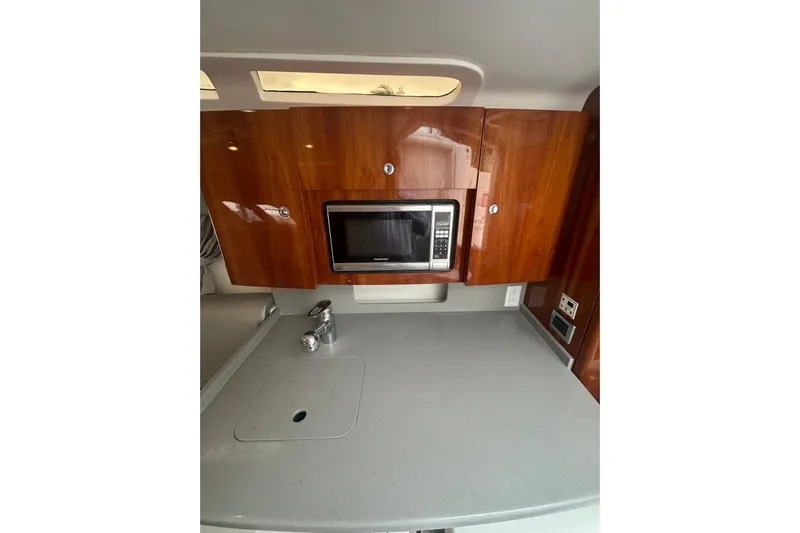  Yacht Photos Pics 2015 Intrepid 400 Cuddy kitchen area with microwave and wooden cabinets.