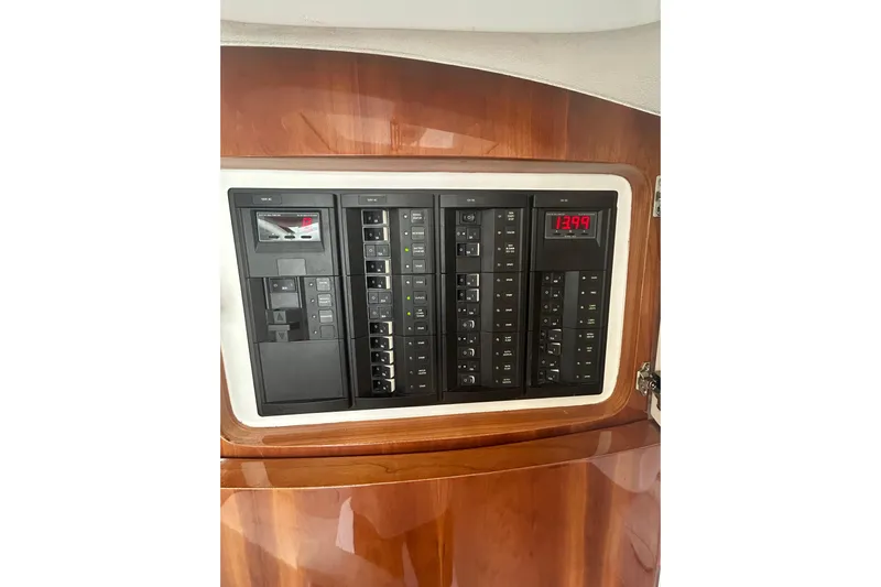  Yacht Photos Pics Control panel of a 2015 Intrepid 400 Cuddy boat, featuring switches and digital display.