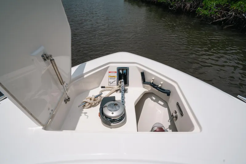 Rock N’ Doc Yacht Photos Pics 2019 Boston Whaler 330 Outrage anchor compartment with rope and winch, open on calm water.