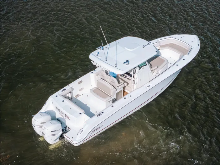 Rock N’ Doc Yacht Photos Pics 2019 Boston Whaler 330 Outrage boat on water, featuring dual Mercury engines.