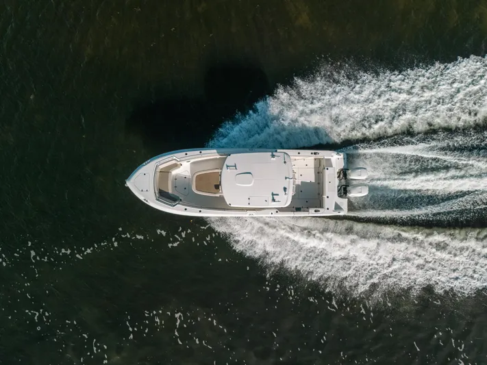 Rock N’ Doc Yacht Photos Pics Aerial view of 2019 Boston Whaler 330 Outrage speeding on water.