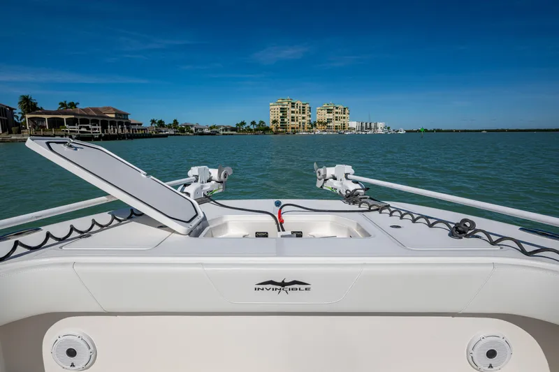 Hoosier Hooker Yacht Photos Pics Invincible 40 Catamaran 2021 on water, open hatch, coastal buildings in background.