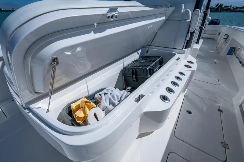 Hoosier Hooker Yacht Photos Pics Open storage compartment on 2021 Invincible 40 Catamaran, featuring organized gear and accessories.