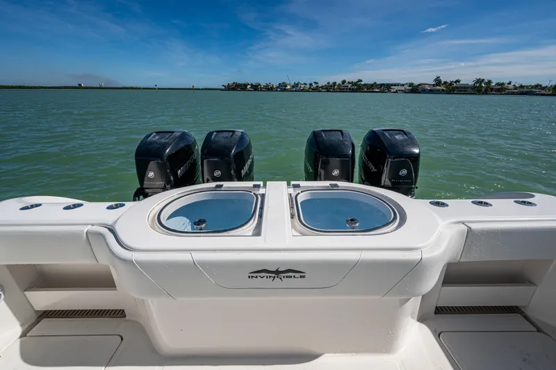 Hoosier Hooker Yacht Photos Pics 2021 Invincible 40 Catamaran with four outboard engines on a calm water backdrop.
