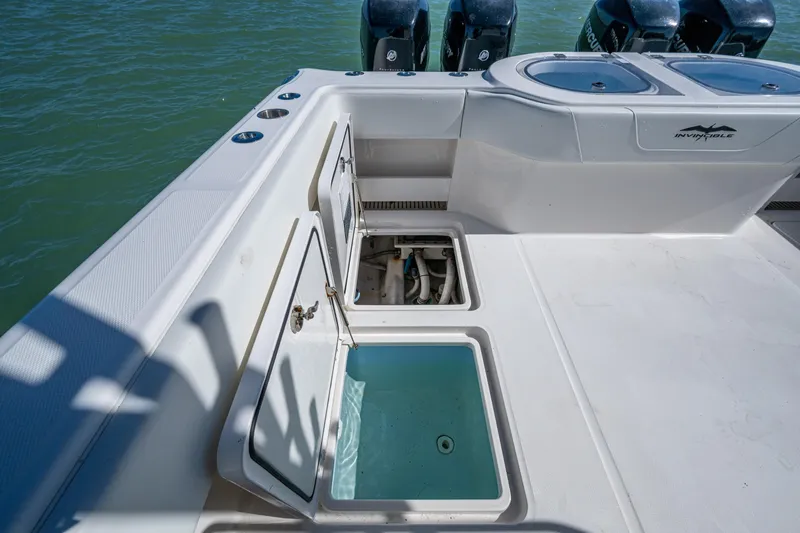 Hoosier Hooker Yacht Photos Pics 2021 Invincible 40 Catamaran deck with open storage compartments and outboard motors.