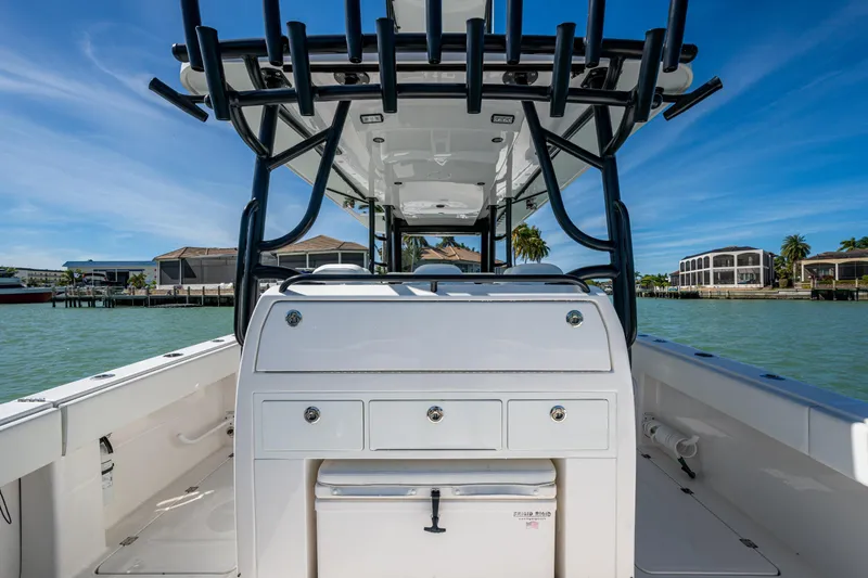 Hoosier Hooker Yacht Photos Pics 2021 Invincible 40 Catamaran interior with rod holders, dockside view, and clear blue sky.