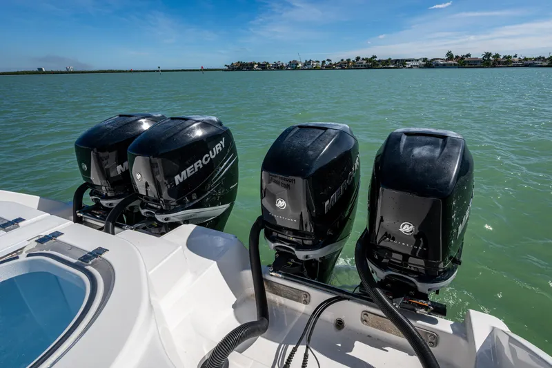 Hoosier Hooker Yacht Photos Pics 2021 Invincible 40 Catamaran with four Mercury outboard engines on a calm sea.