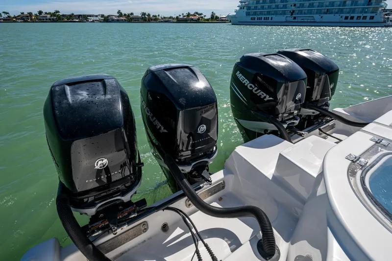 Hoosier Hooker Yacht Photos Pics Four Mercury outboard engines on a 2021 Invincible 40 Catamaran in a sunny marina.