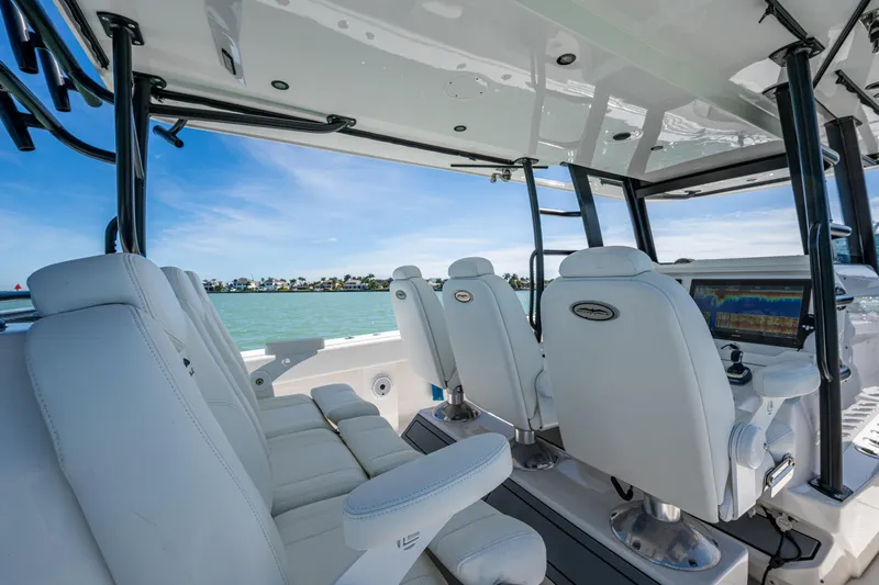 Hoosier Hooker Yacht Photos Pics Interior of 2021 Invincible 40 Catamaran with white seating and advanced navigation system.