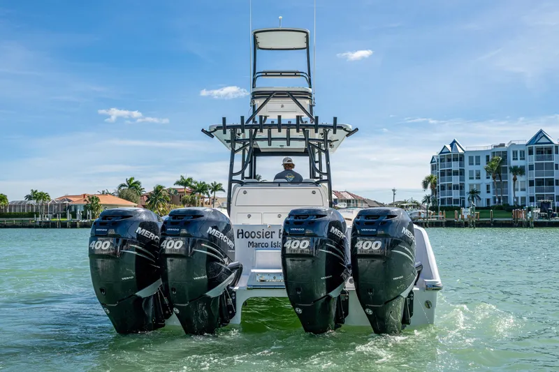 Hoosier Hooker Yacht Photos Pics 2021 Invincible 40 Catamaran with four Mercury 400 engines on water near buildings.