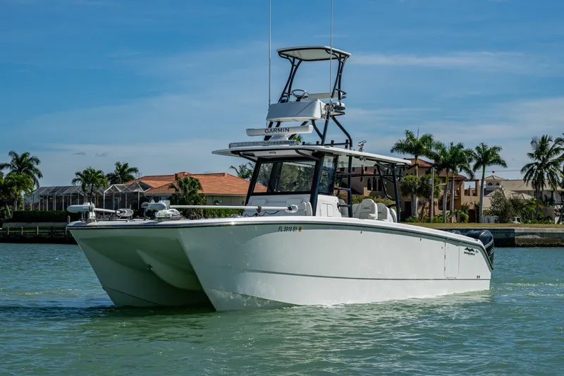 Hoosier Hooker Yacht Photos Pics 2021 Invincible 40 Catamaran on water, tropical background, clear sky.