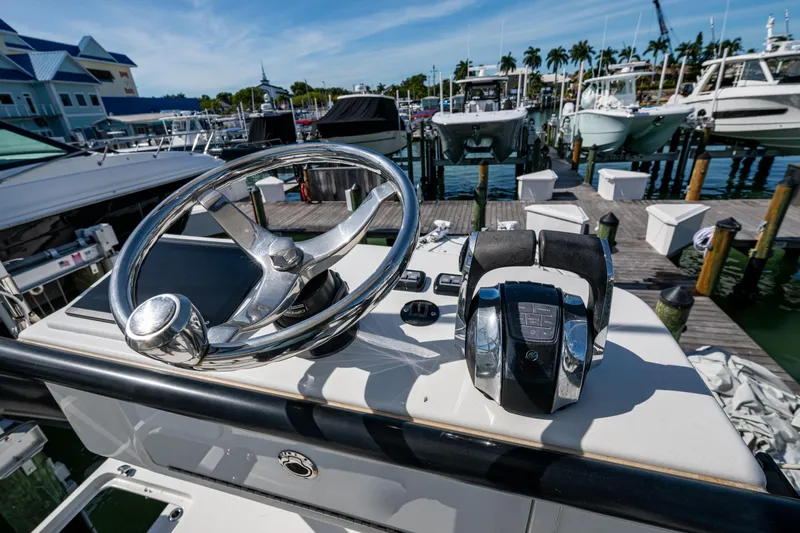 Hoosier Hooker Yacht Photos Pics Helm of 2021 Invincible 40 Catamaran at marina, featuring steering wheel and controls.