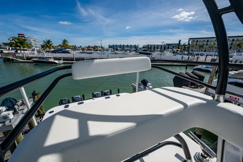 Hoosier Hooker Yacht Photos Pics 2021 Invincible 40 Catamaran helm view at marina, clear skies, and waterfront buildings.