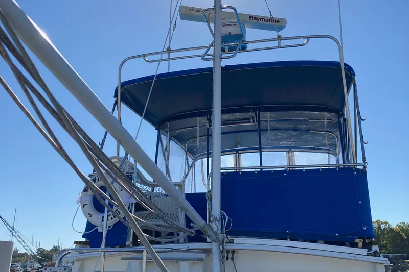  Yacht Photos Pics 1983 Grand Banks 42 Classic yacht with blue canopy and radar equipment.