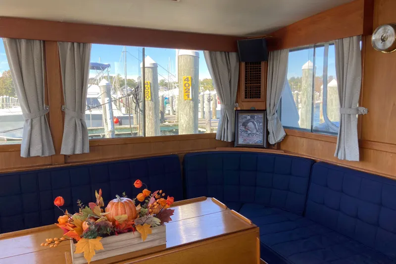  Yacht Photos Pics Interior of 1983 Grand Banks 42 Classic yacht with cozy seating and autumn decor.