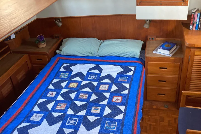 Yacht Photos Pics Cozy bedroom in 1983 Grand Banks 42 Classic yacht with nautical-themed quilt.