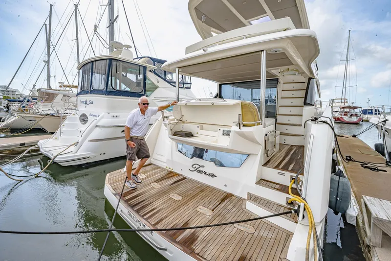 Tara Yacht Photos Pics 2017 Absolute 50 Fly yacht docked, featuring spacious deck and elegant design.