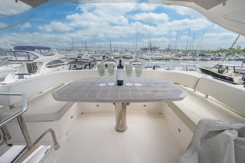 Tara Yacht Photos Pics Luxurious 2017 Absolute 50 Fly yacht with elegant seating and scenic marina view.