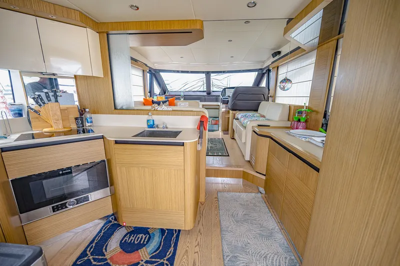 Tara Yacht Photos Pics Interior of 2017 Absolute 50 Fly yacht with modern kitchen and seating area.