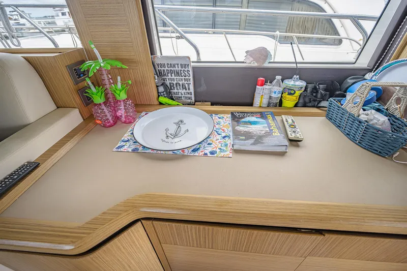 Tara Yacht Photos Pics Interior of 2017 Absolute 50 Fly yacht with decorative items and nautical-themed plate.