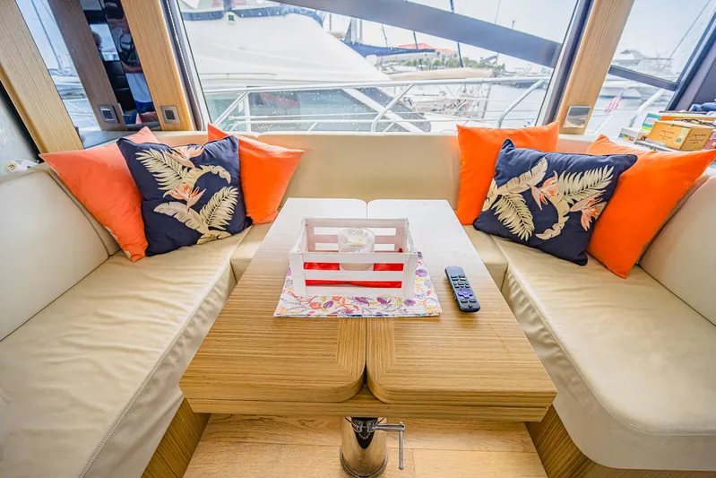 Tara Yacht Photos Pics Luxurious interior of 2017 Absolute 50 Fly yacht with vibrant cushions and wooden table.