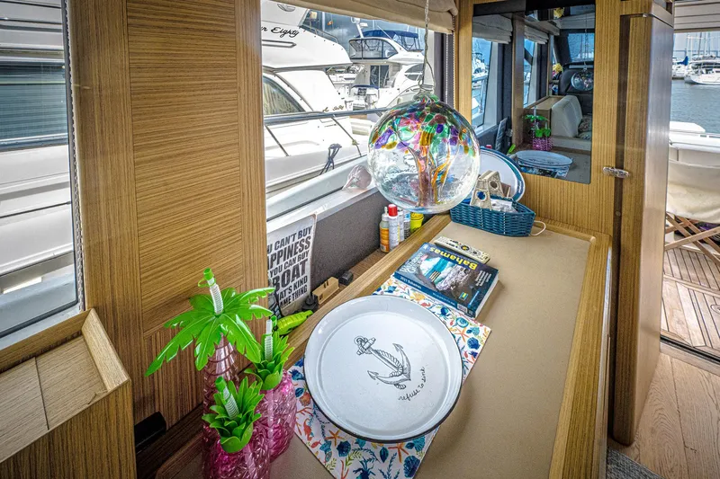 Tara Yacht Photos Pics Interior of 2017 Absolute 50 Fly yacht with decorative items and marina view.
