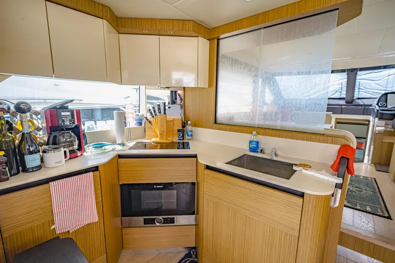 Tara Yacht Photos Pics Modern kitchen in 2017 Absolute 50 Fly yacht with appliances and wooden cabinetry.