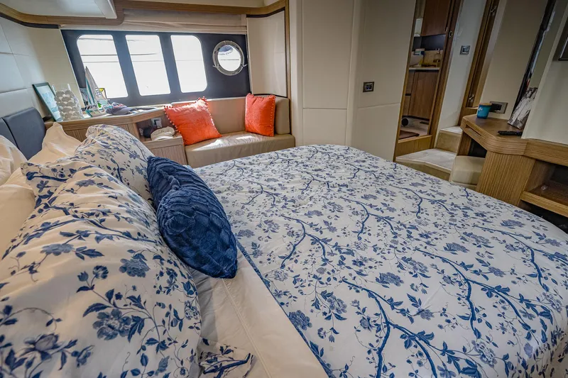 Tara Yacht Photos Pics Luxurious bedroom interior of 2017 Absolute 50 Fly yacht with floral bedding and cozy seating.