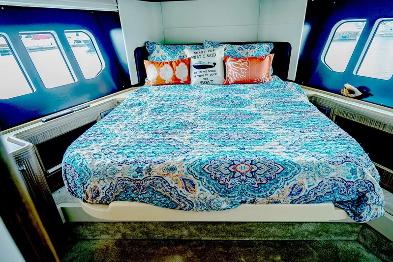 Tara Yacht Photos Pics Luxurious bedroom interior of 2017 Absolute 50 Fly yacht with vibrant bedding and scenic windows.