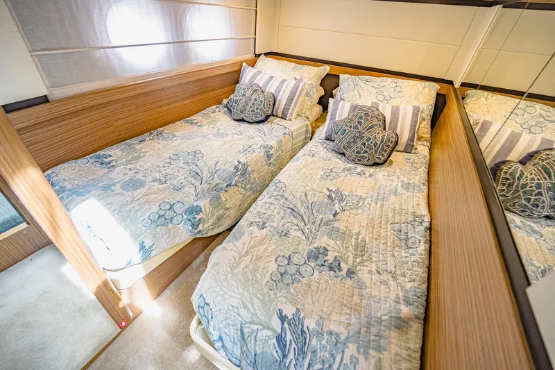 Tara Yacht Photos Pics Luxurious twin beds in 2017 Absolute 50 Fly yacht cabin, featuring elegant bedding and wood accents.