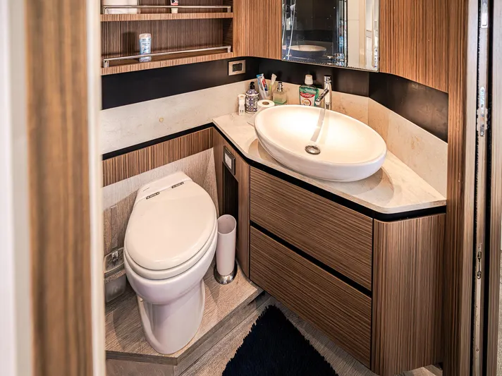 Tara Yacht Photos Pics Luxurious bathroom in 2017 Absolute 50 Fly yacht with modern fixtures and wood accents.