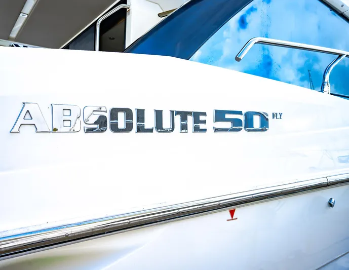 Tara Yacht Photos Pics Close-up of 2017 Absolute 50 Fly yacht nameplate on white hull.