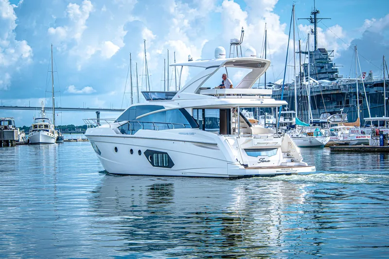 Tara Yacht Photos Pics Luxury Absolute 50 Fly yacht from 2017 cruising in a scenic marina.