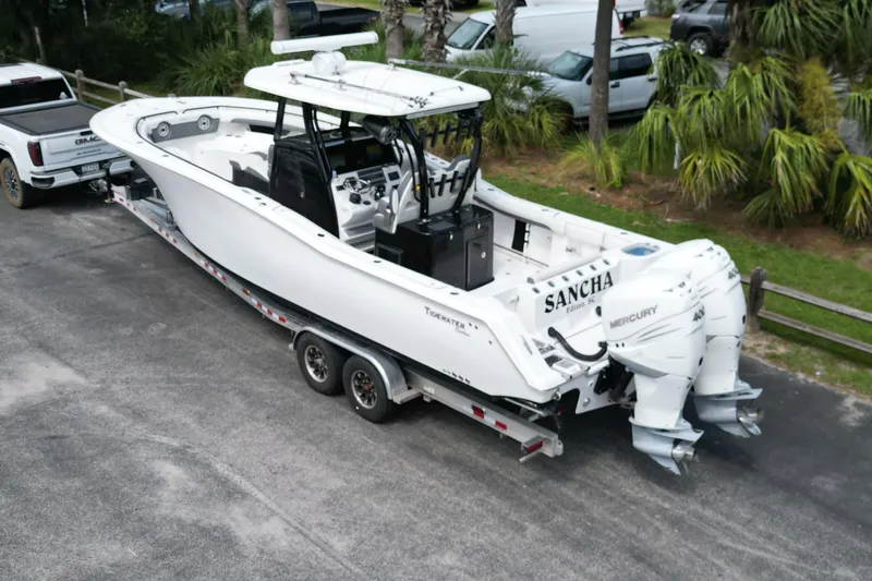 Yacht Photos Pics 2020 Tidewater 320 CC Adventure boat on trailer, featuring dual Mercury engines.