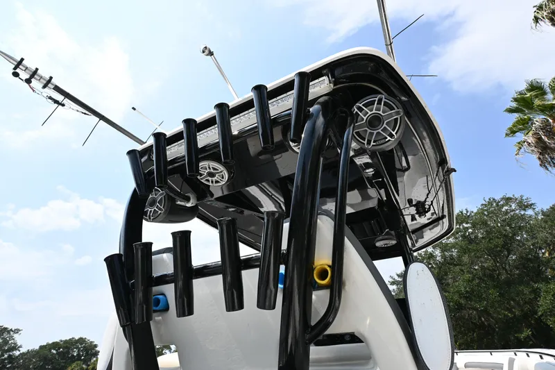  Yacht Photos Pics Tidewater 320 CC Adventure 2020 boat with rod holders and speakers under a clear sky.