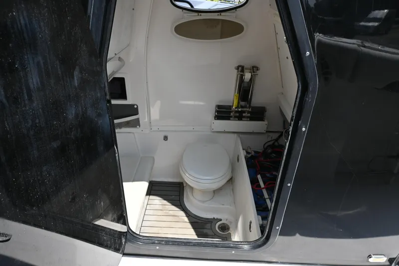  Yacht Photos Pics 2020 Tidewater 320 CC Adventure boat interior with compact marine toilet.