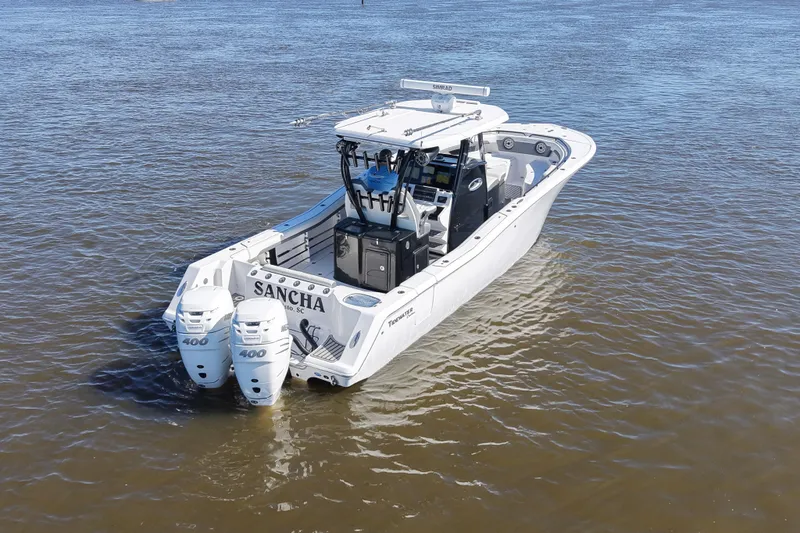  Yacht Photos Pics 2020 Tidewater 320 CC Adventure boat on water with dual engines.