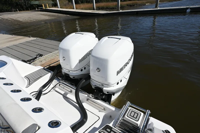  Yacht Photos Pics Twin Mercury outboard engines on a 2020 Tidewater 320 CC Adventure boat at a dock.