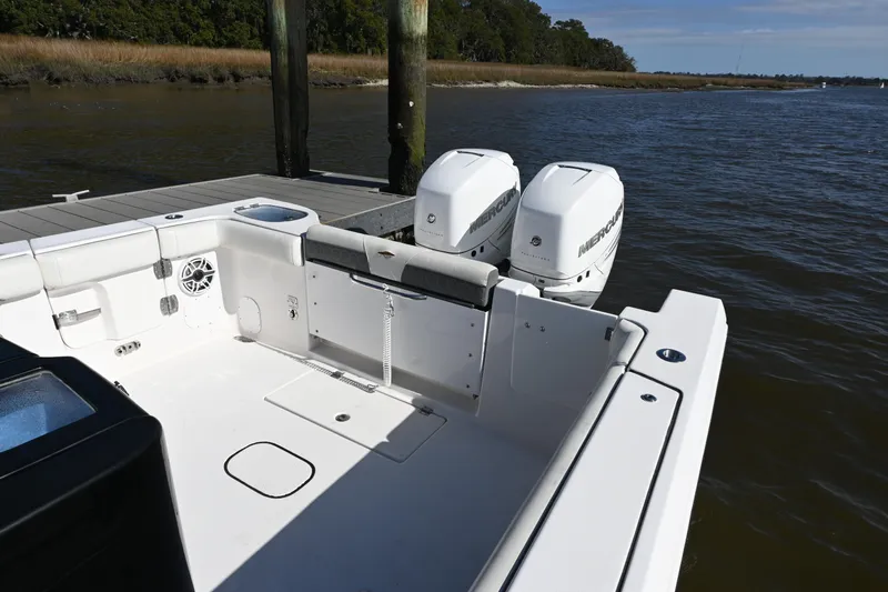  Yacht Photos Pics 2020 Tidewater 320 CC Adventure boat with dual Mercury engines docked by the water.