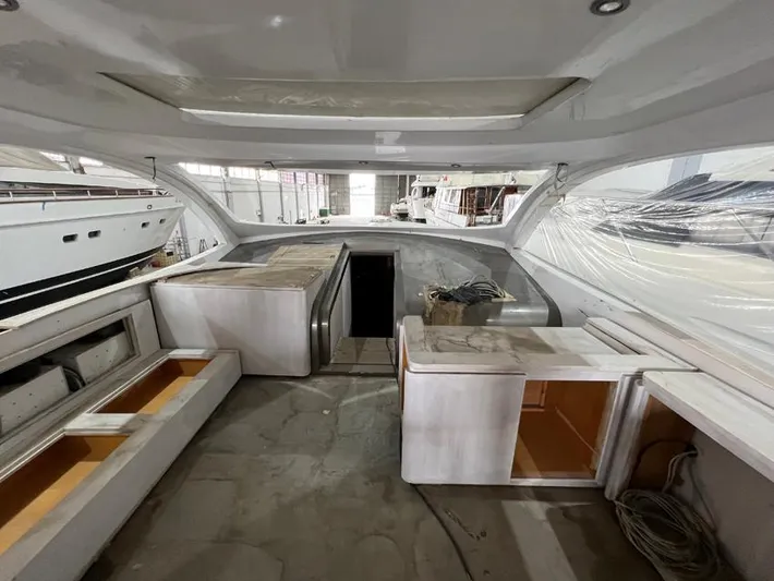 Yacht Photos Pics Interior view of a 2023 Custom KAITOS 68 yacht under construction in a shipyard.