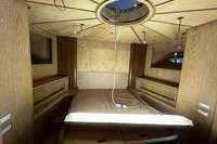 Interior of 2023 Custom KAITOS 68 yacht, featuring wooden paneling and modern design elements.