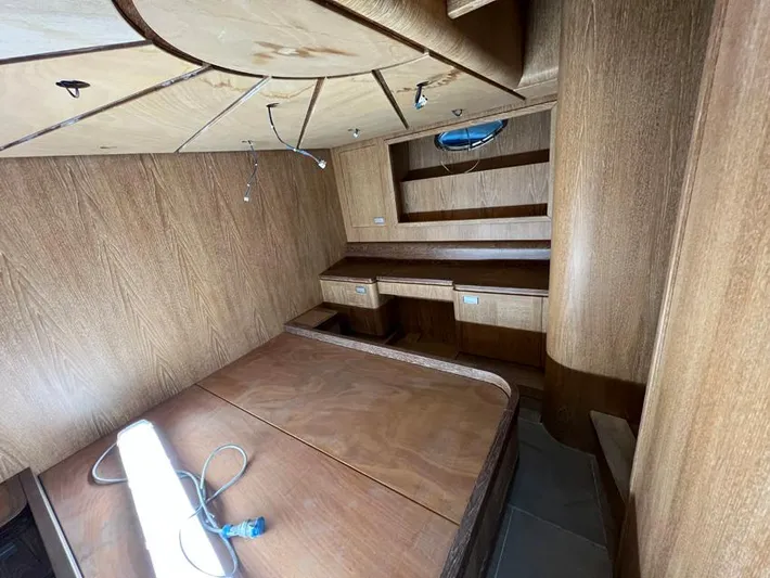  Yacht Photos Pics Interior of 2023 Custom KAITOS 68 yacht with wooden furnishings and built-in shelves.