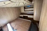 Interior of 2023 Custom KAITOS 68 yacht with wooden furnishings and built-in shelves.