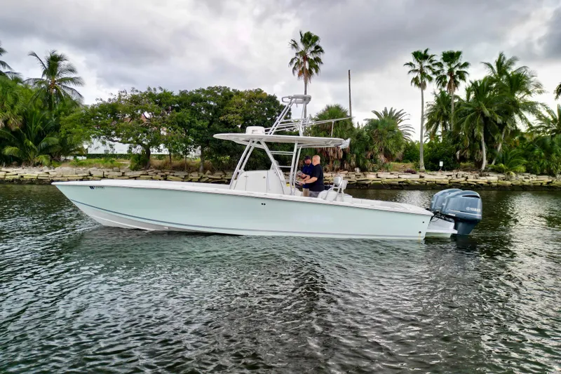 Ribeye Yacht Photos Pics 2005 Jupiter 31 Center Console boat on water, surrounded by palm trees.